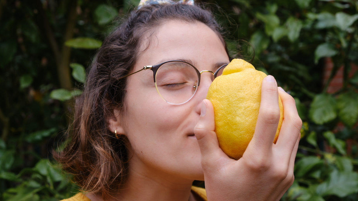 Woman Smelling Lemons