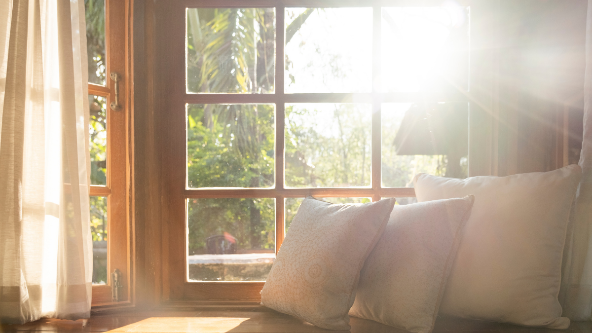 Cozy home, pillows near window light