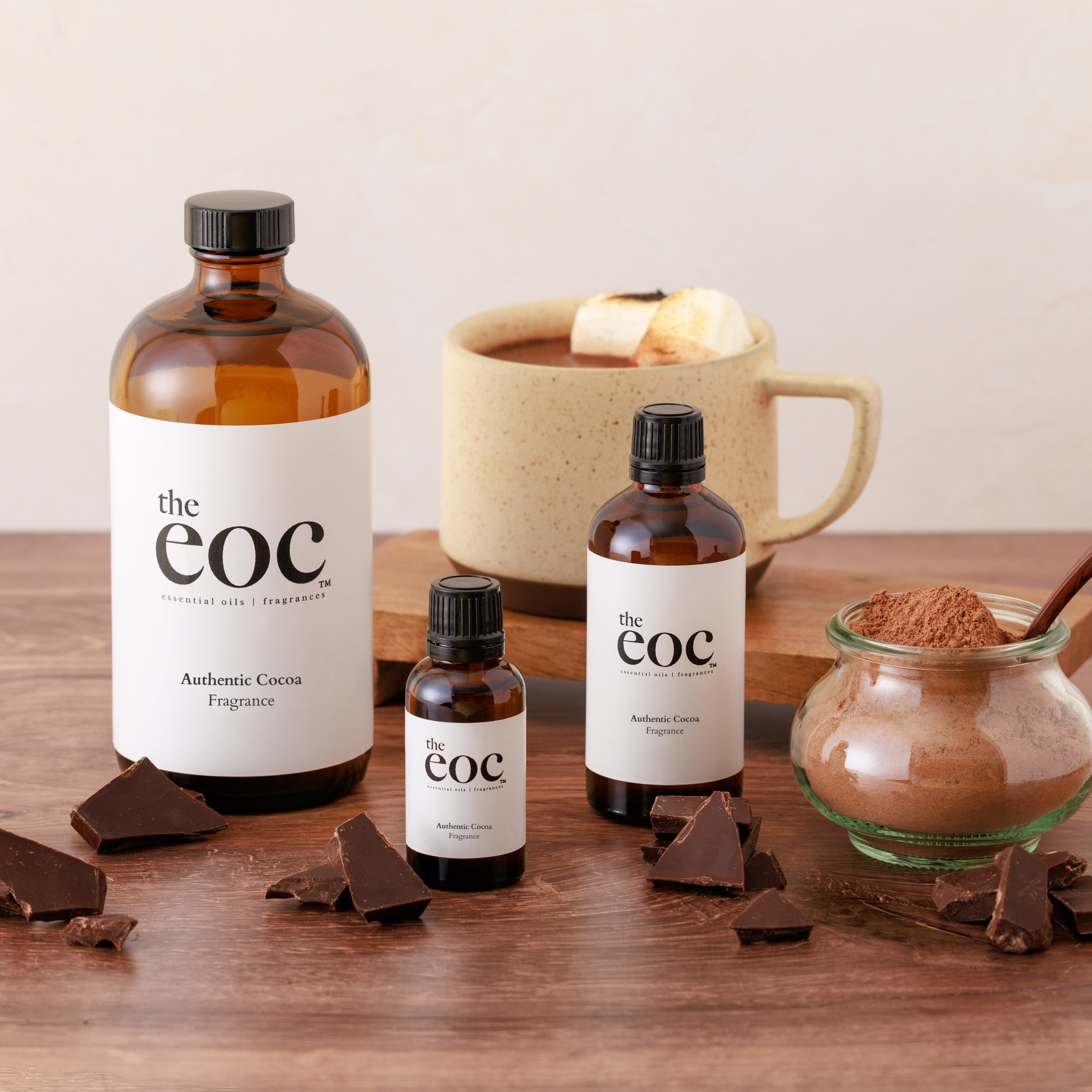 Bottles of 'the eoc' with cocoa products on a wooden surface