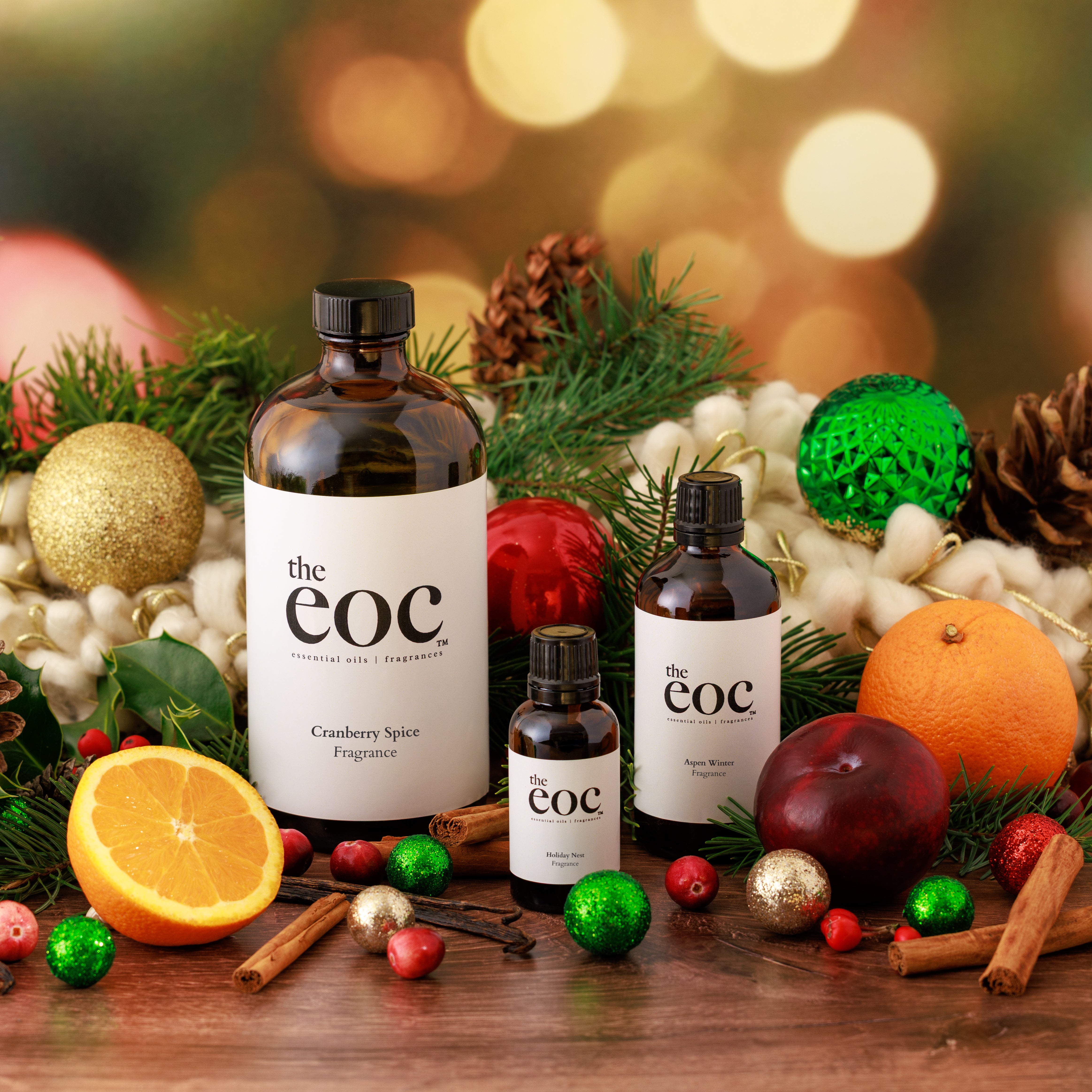 Bottles of 'the eoc' with Christmas decorations on a wooden surface