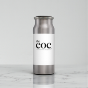 Silver and white bottle with 'the eoc' label on a marble surface