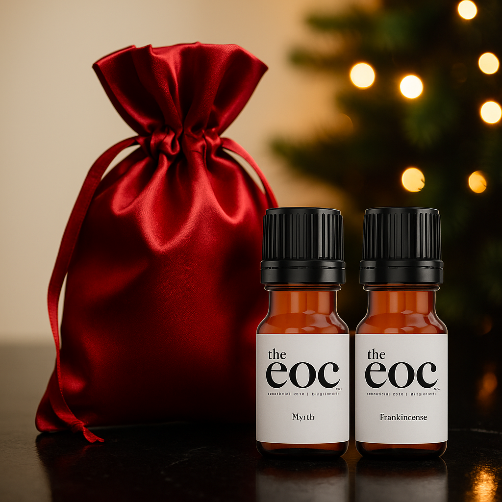 Two bottles of 'the eoc' with a red satin bag and blurred lights in the background