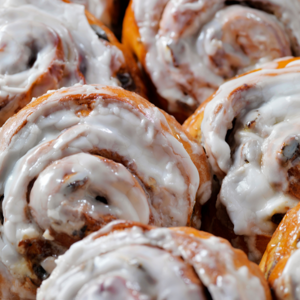Close-up of cinnamon rolls with white icing