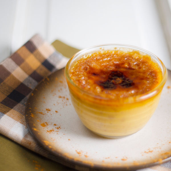 Creme bréleé in a glass dish on a checkered cloth