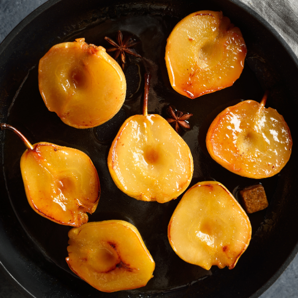 Roasted pears with star anise on a dark surface