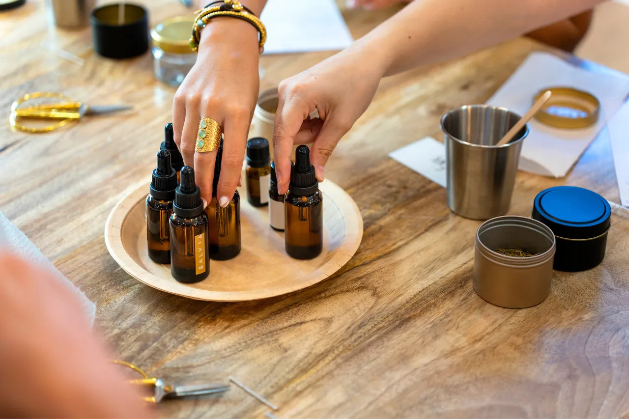 Hands preparing custom essential oil blends